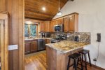 Remodeled kitchen with granite counters and stainless steel appliances